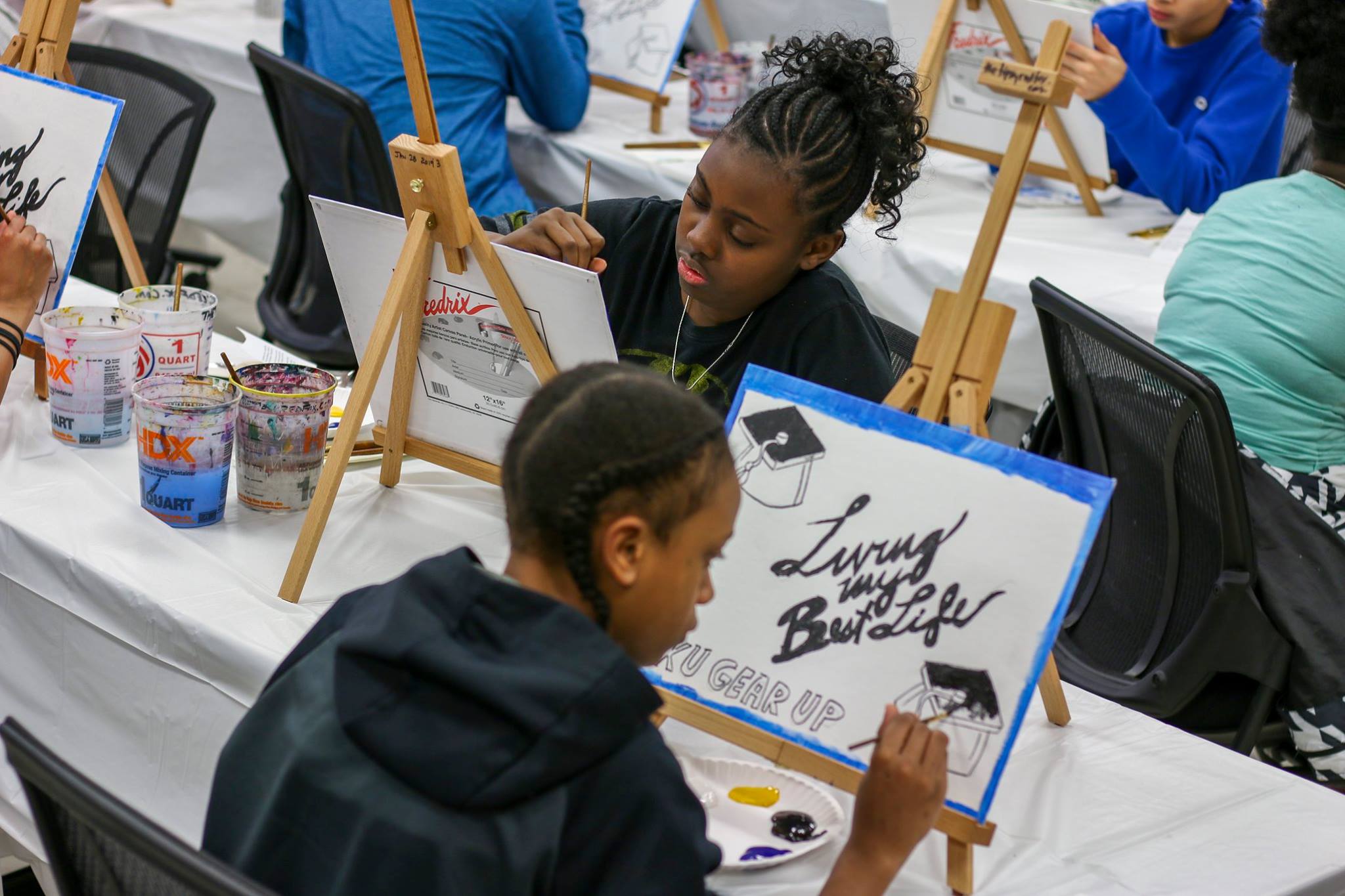 Two female studnets painting